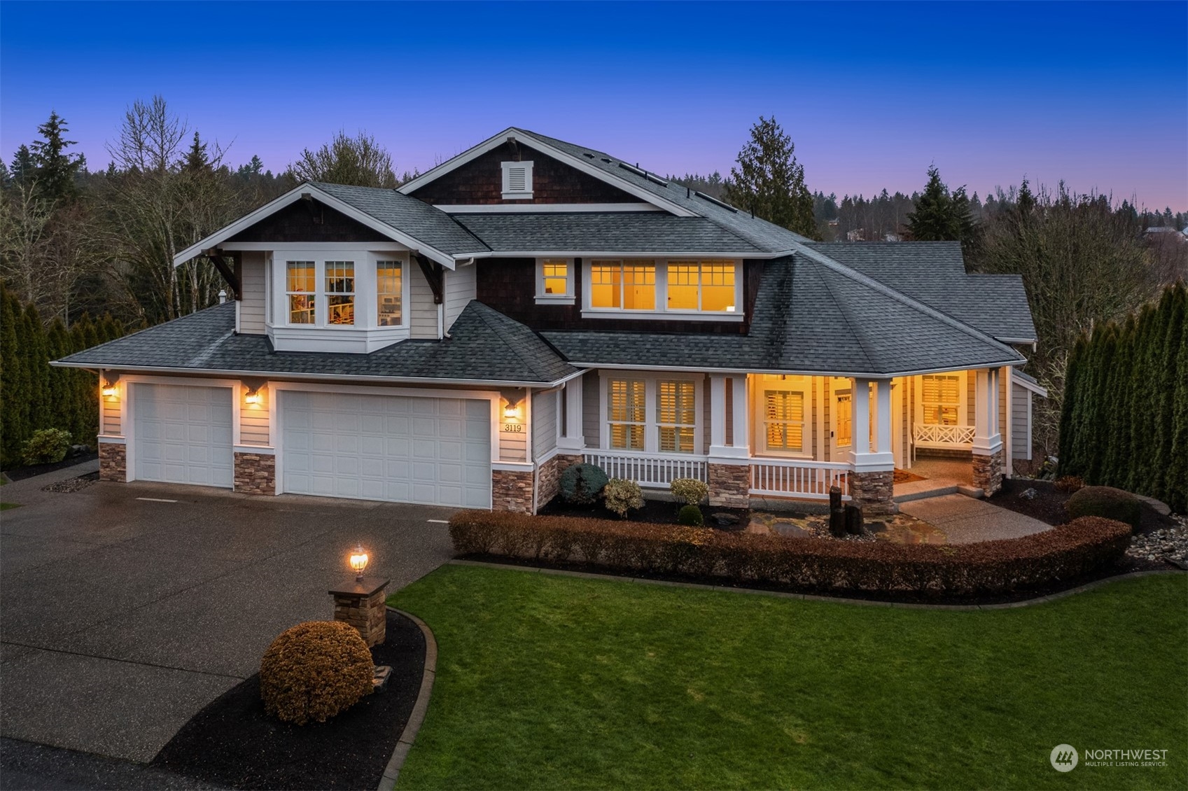 a front view of a house with a garden and yard