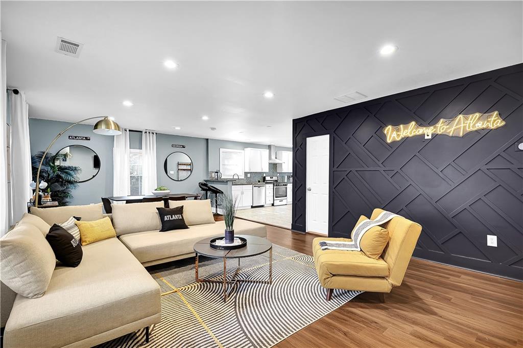 a living room with furniture and a flat screen tv