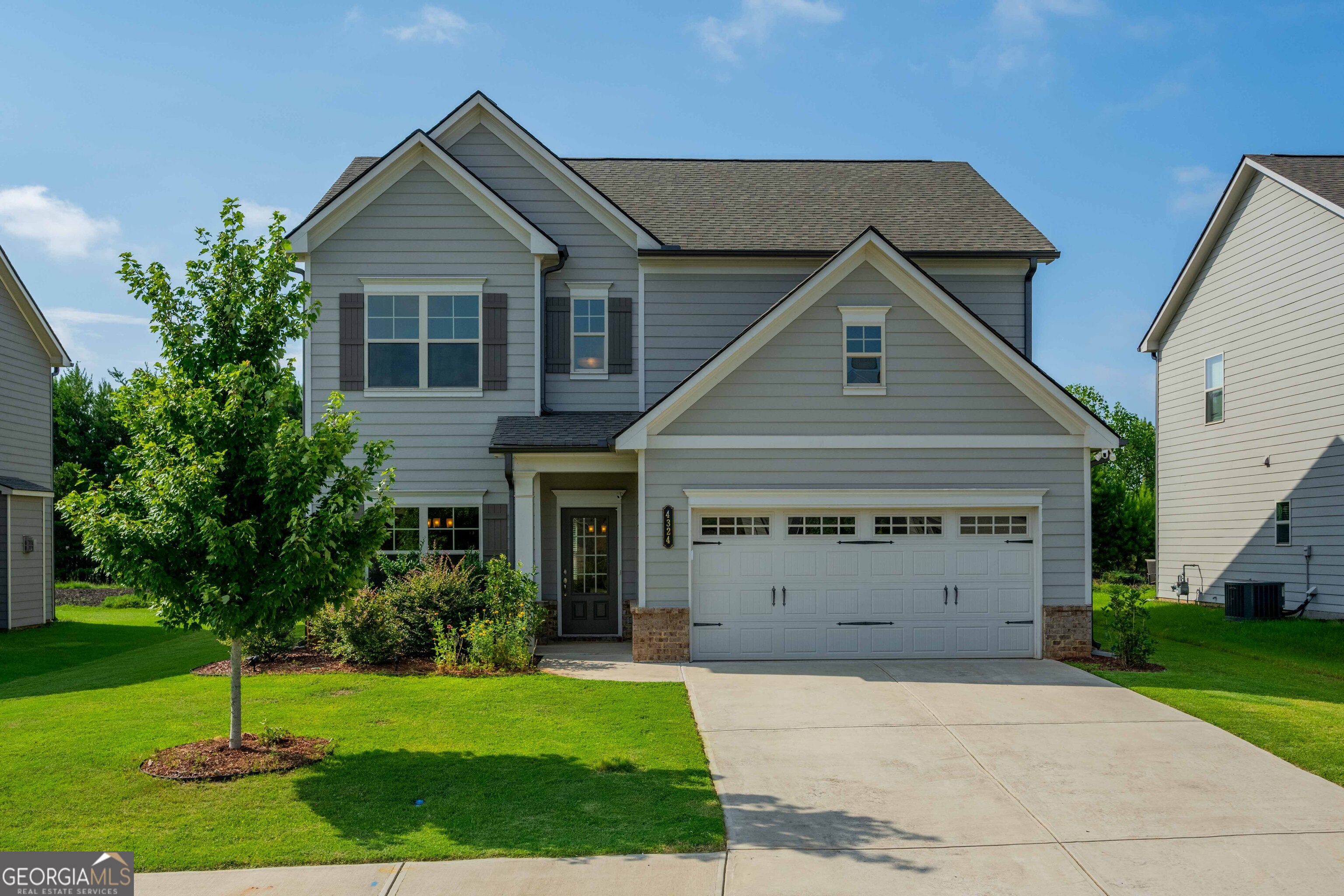 a front view of a house with a yard and garage