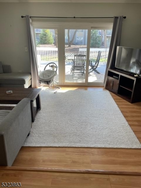 a living room with a floor to ceiling window and a table