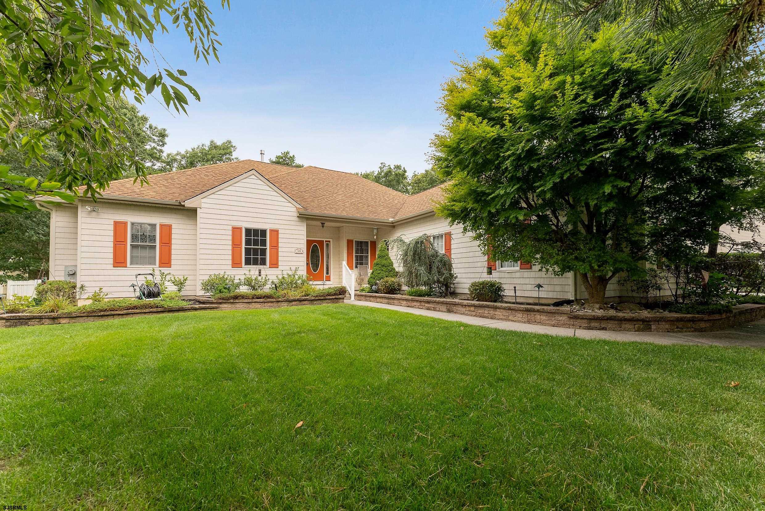 a front view of a house with a garden and porch