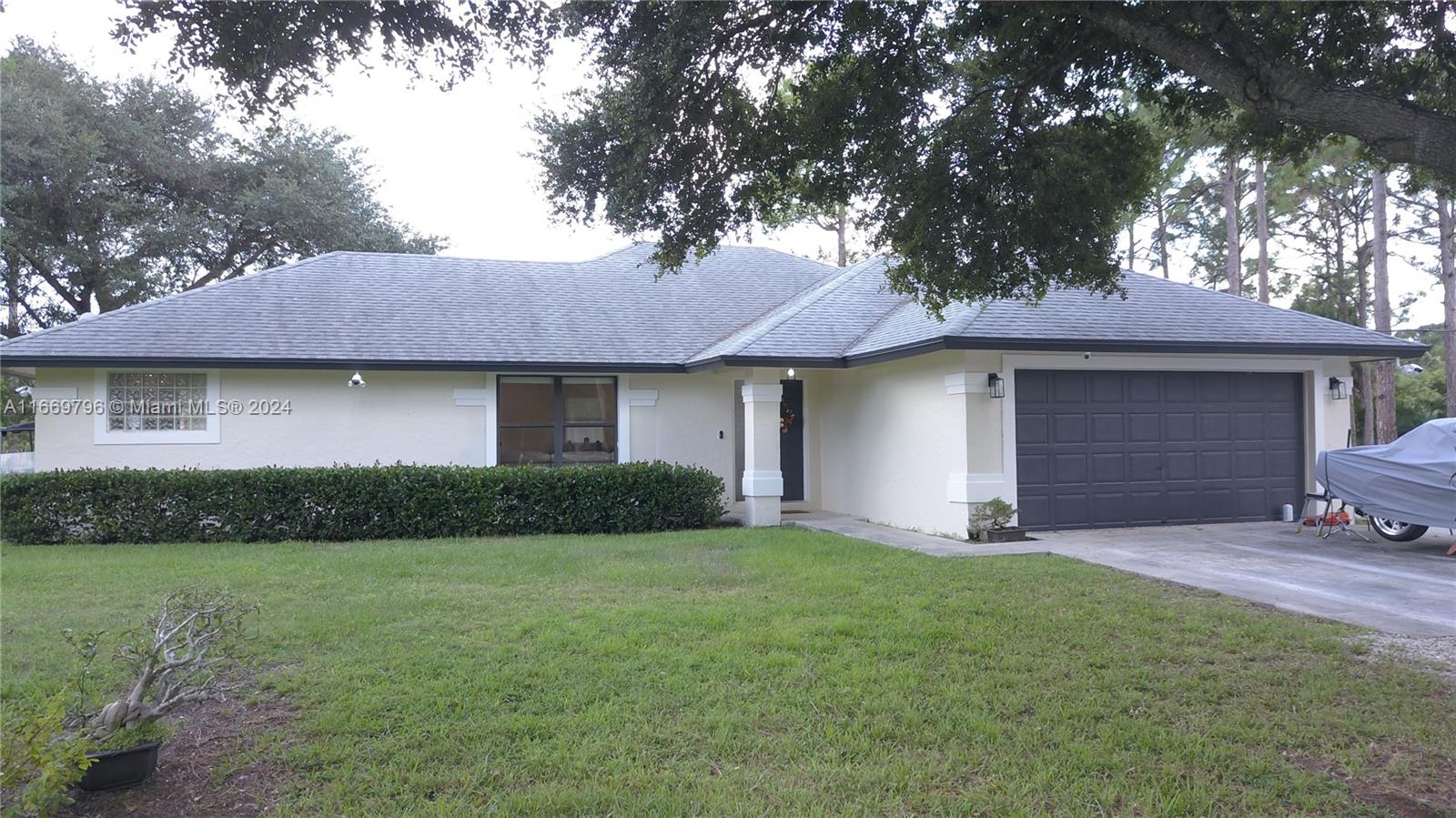 a front view of a house with a garden and yard