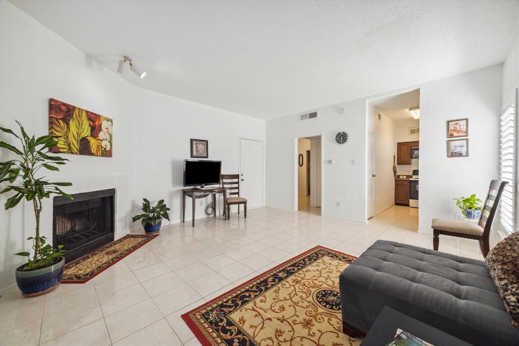 Step into the inviting open-concept living and dining area, where natural light floods the space through expansive windows, creating a warm and welcoming ambiance.