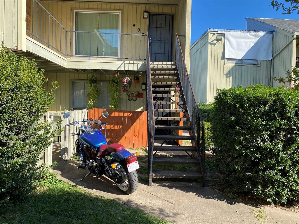 a view of a wooden bench with a bench in front of house