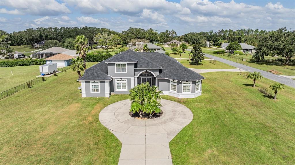 a view of a big house with a yard