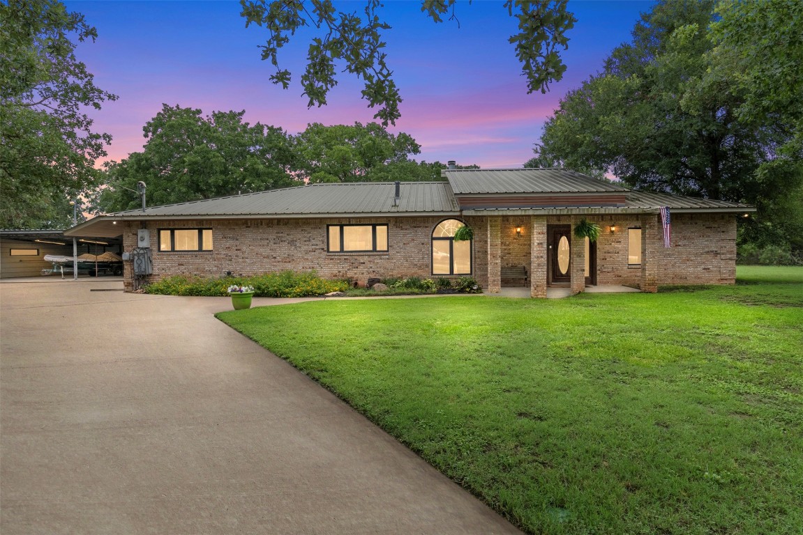 a front view of a house with a garden and yard