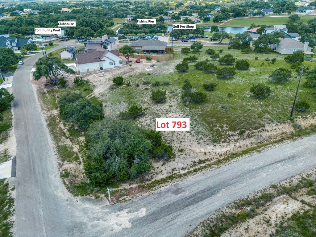 an aerial view of residential house and car parked on street side