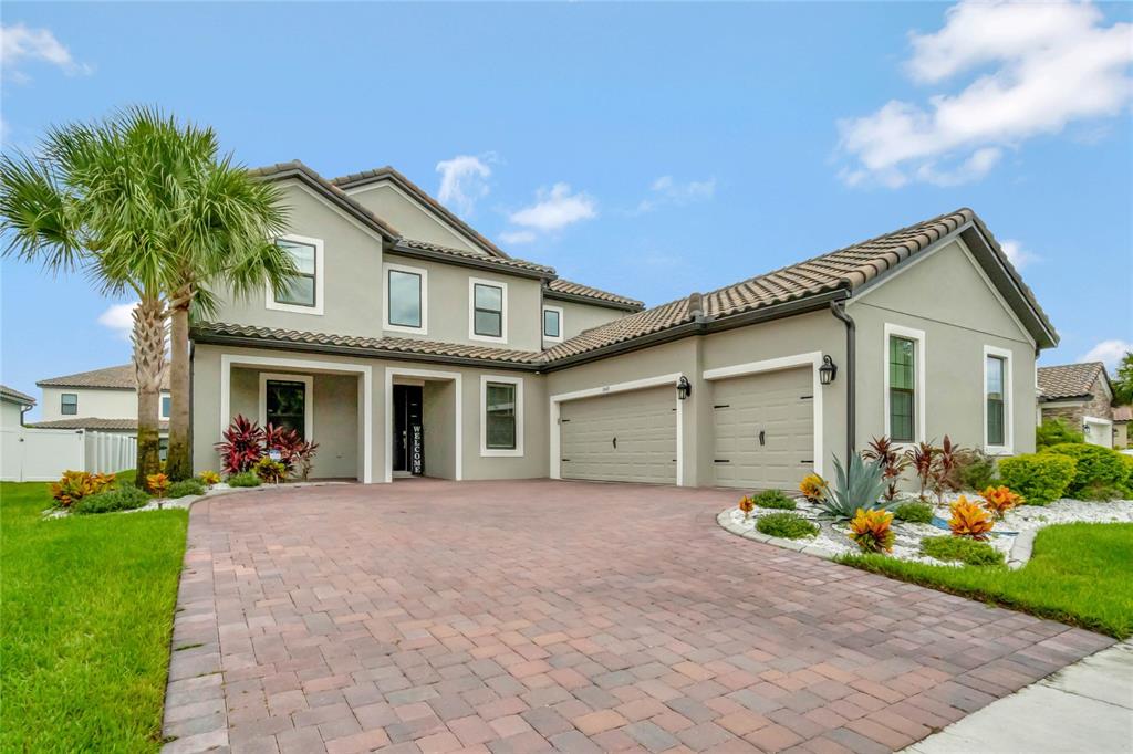 a front view of a house with a yard and garage