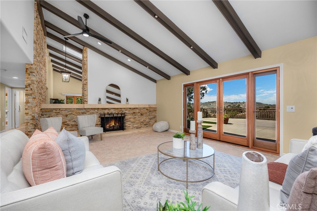 Large living room with views of hills and fireplace