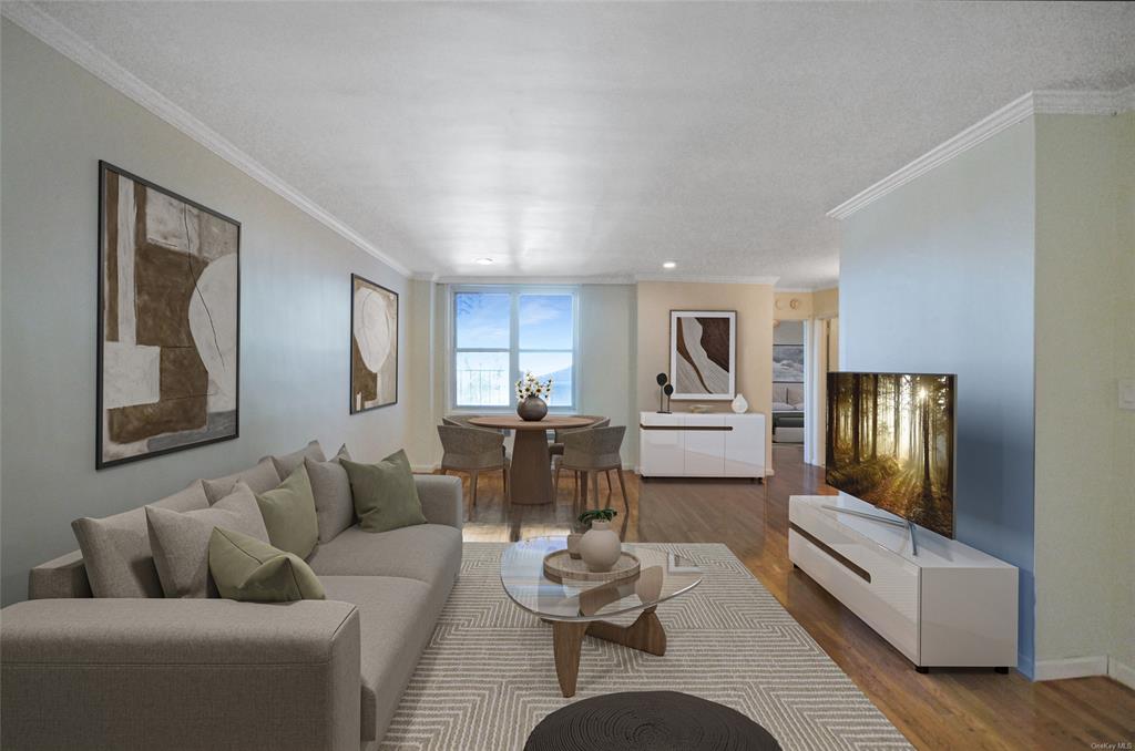 Living room with hardwood / wood-style floors and crown molding