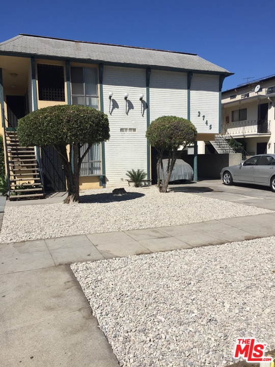 a front view of a house with parking space