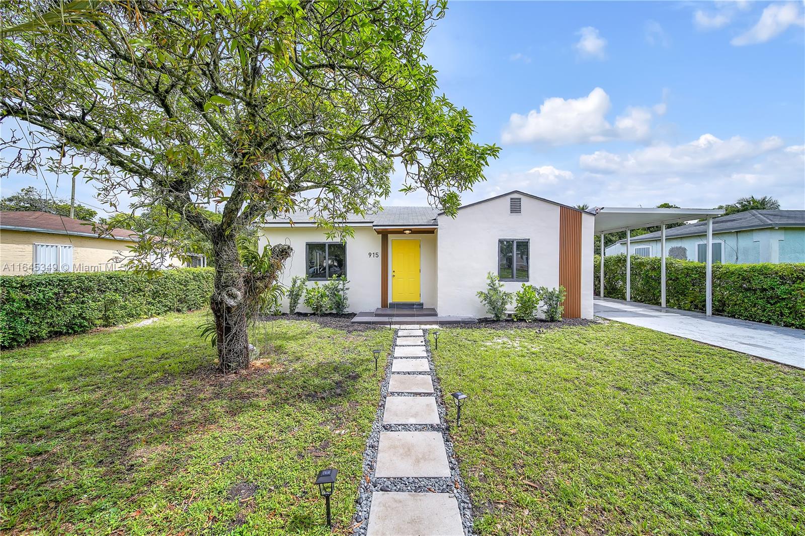 a front view of a house with yard and green space