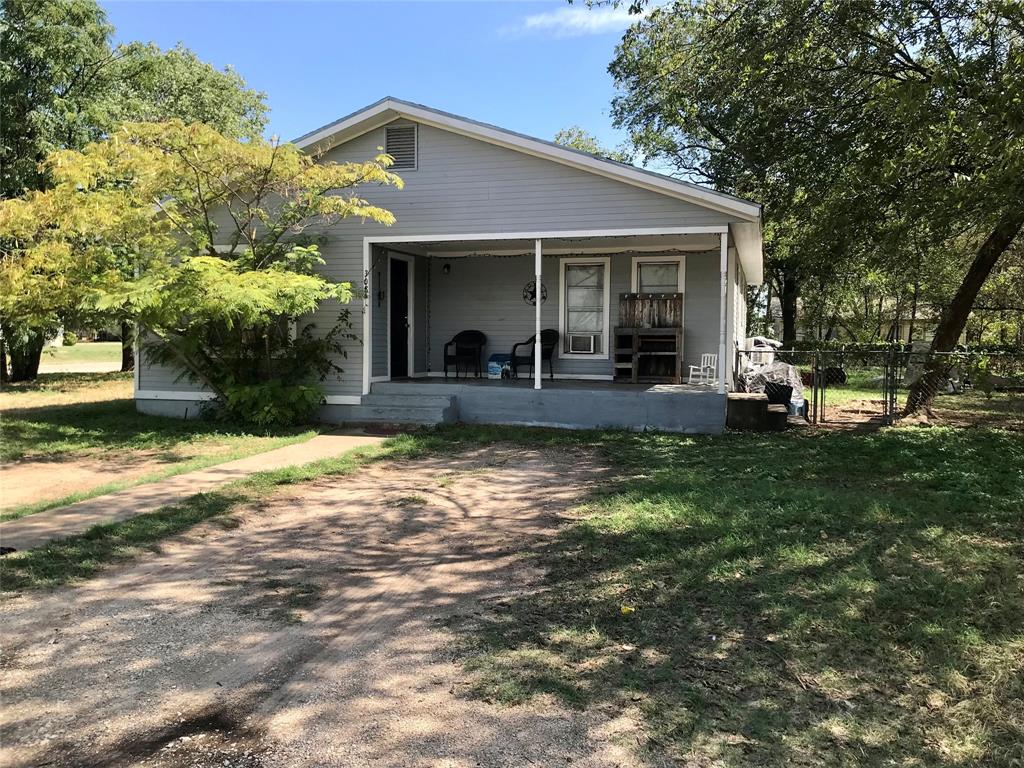 a front view of a house with a yard table and chairs