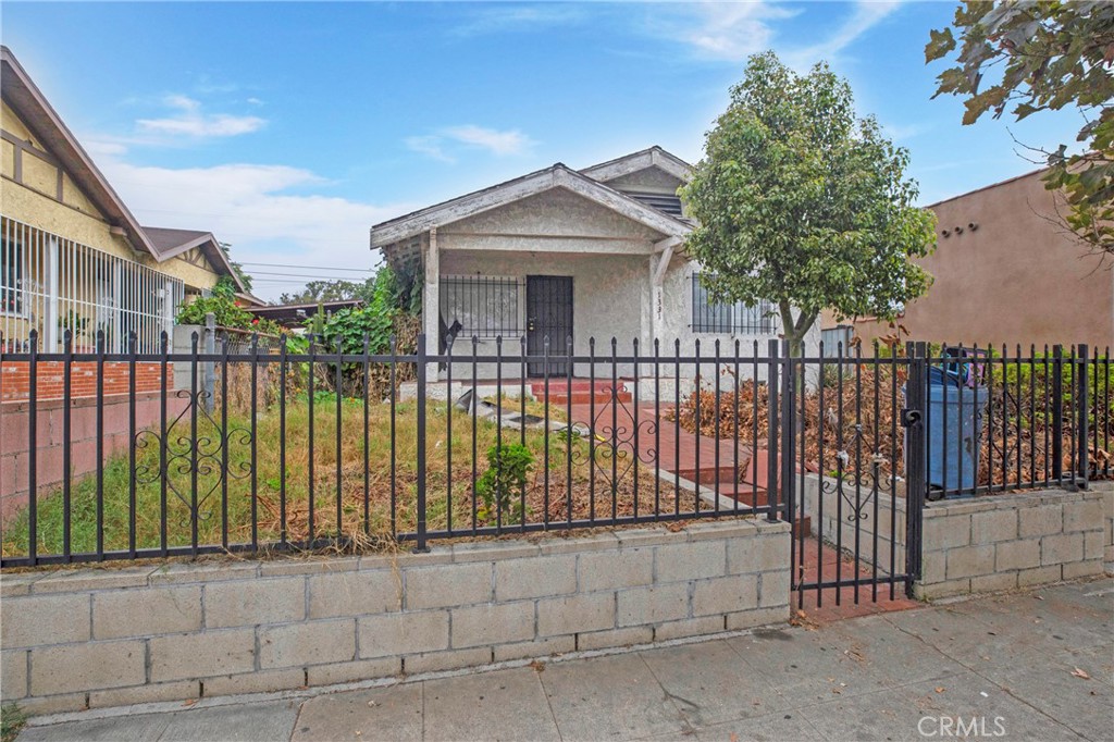 a view of a wrought iron fences in front of house