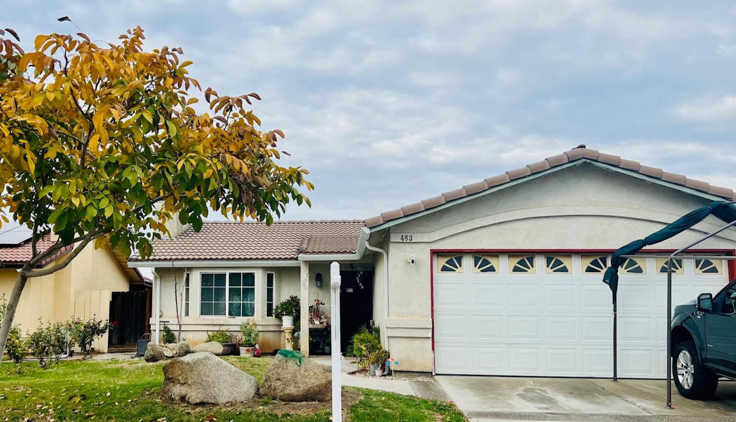 a front view of a house with garden