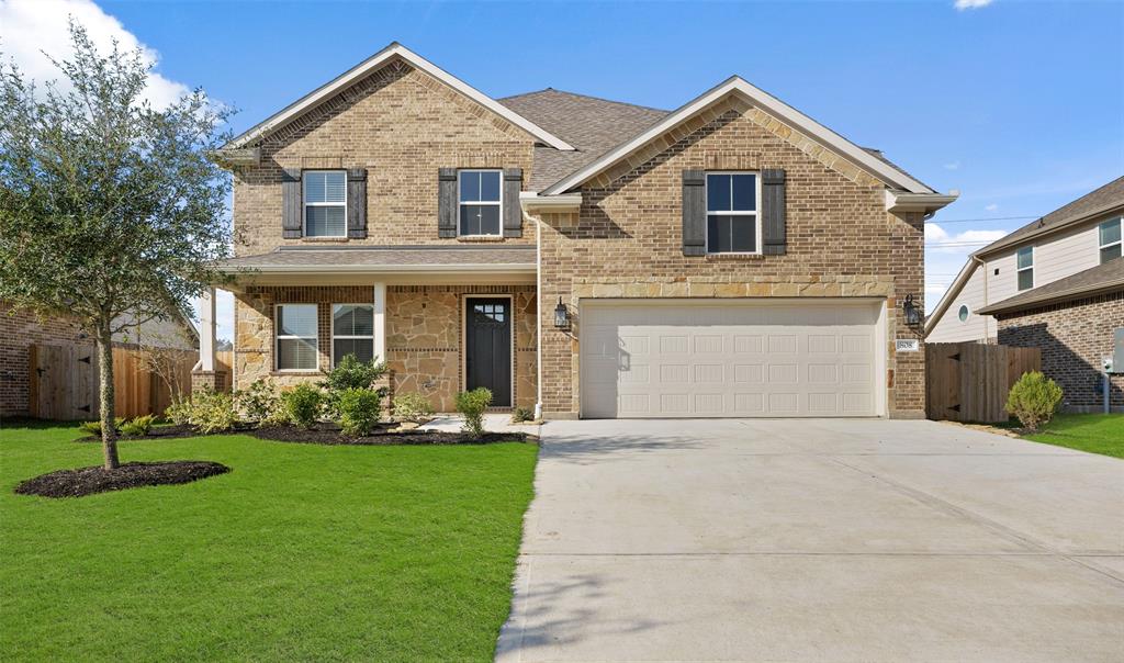 a front view of a house with a yard and garage