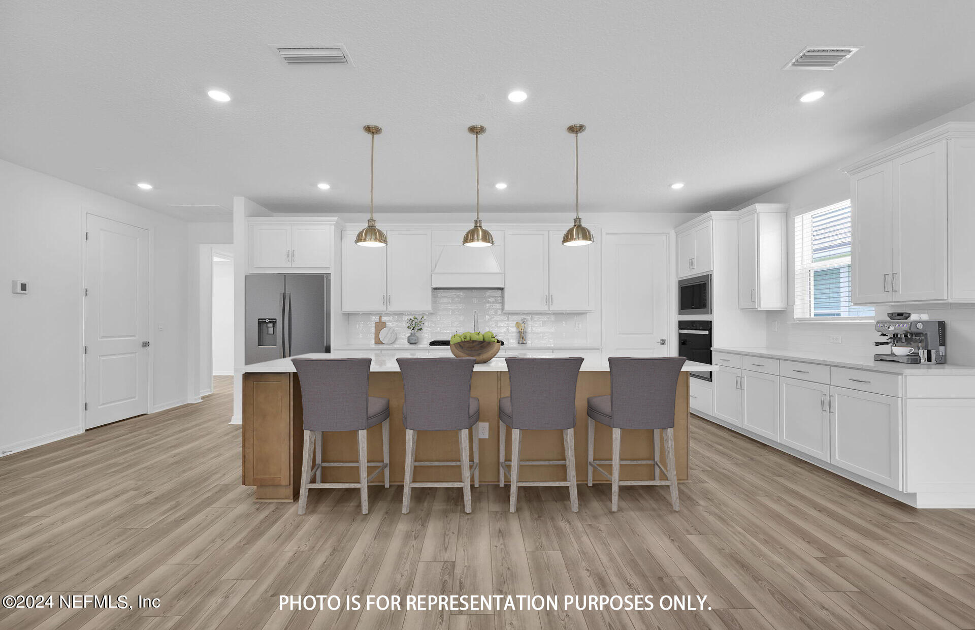 a large kitchen with a table and chairs