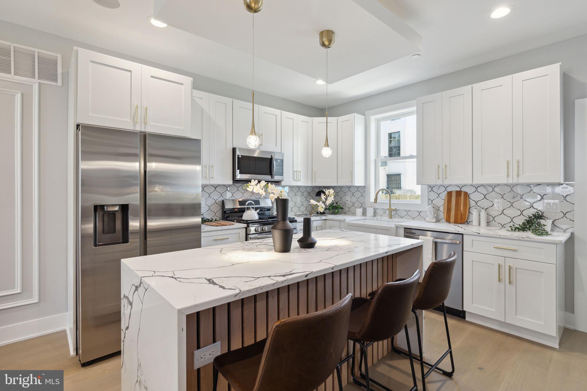 a kitchen with a dining table chairs and refrigerator