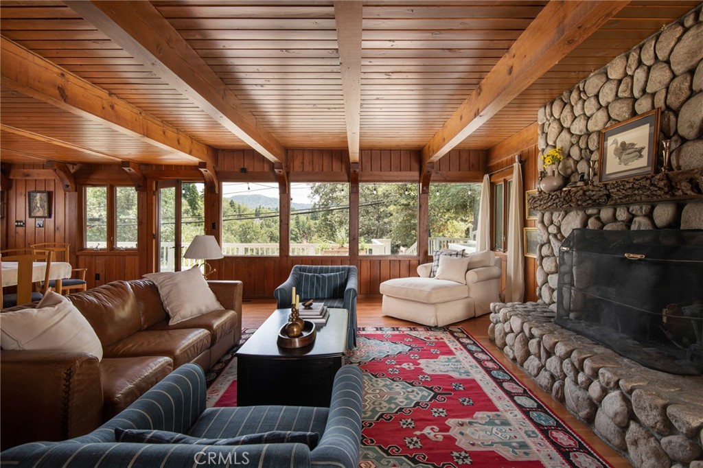 a living room with furniture and a floor to ceiling window