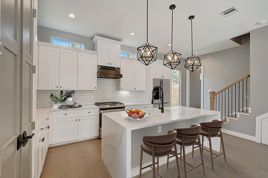 a kitchen with a dining table chairs sink and stove