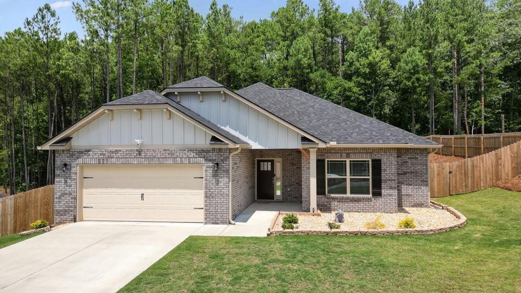 a front view of a house with a yard garage and outdoor seating