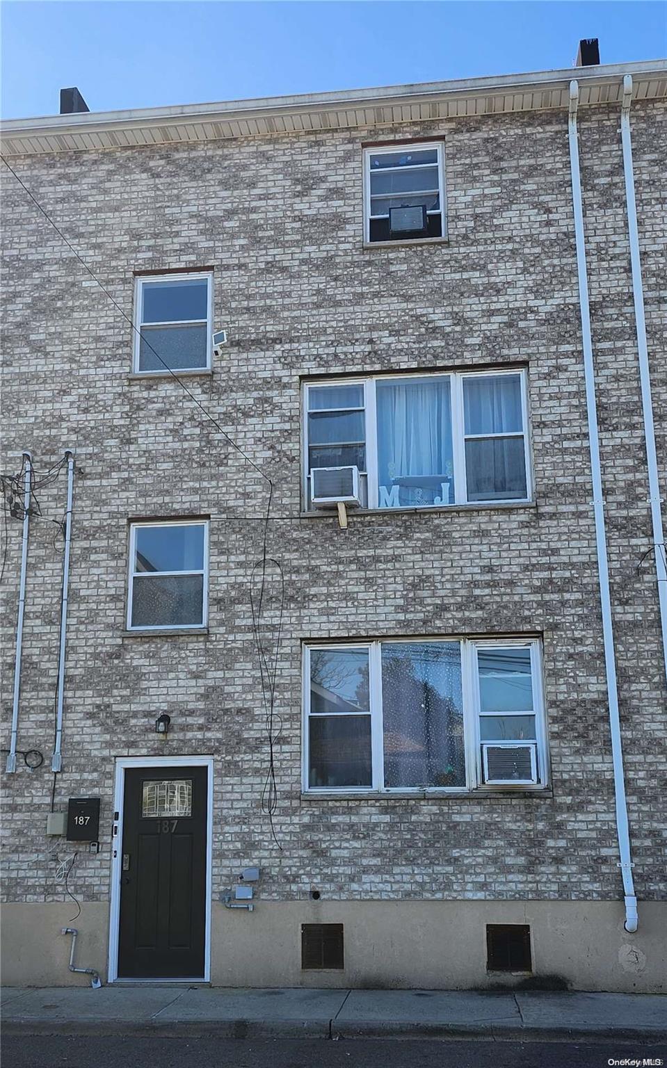 a brick house with a door and a yard