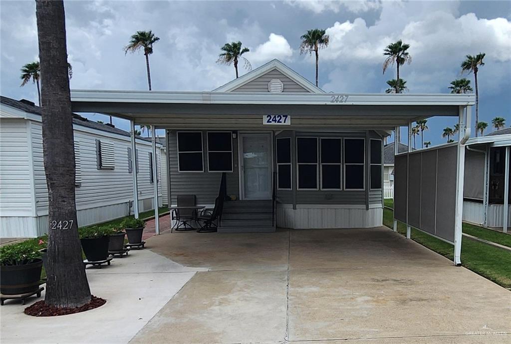 a front view of a house with sitting area