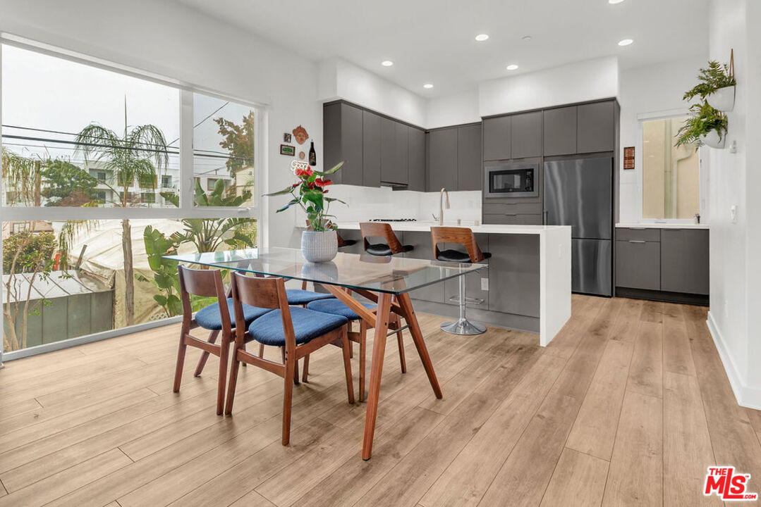 a dining room with furniture and wooden floor