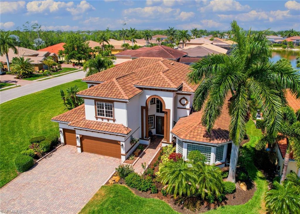 Mediterranean / spanish house featuring a garage and a front lawn