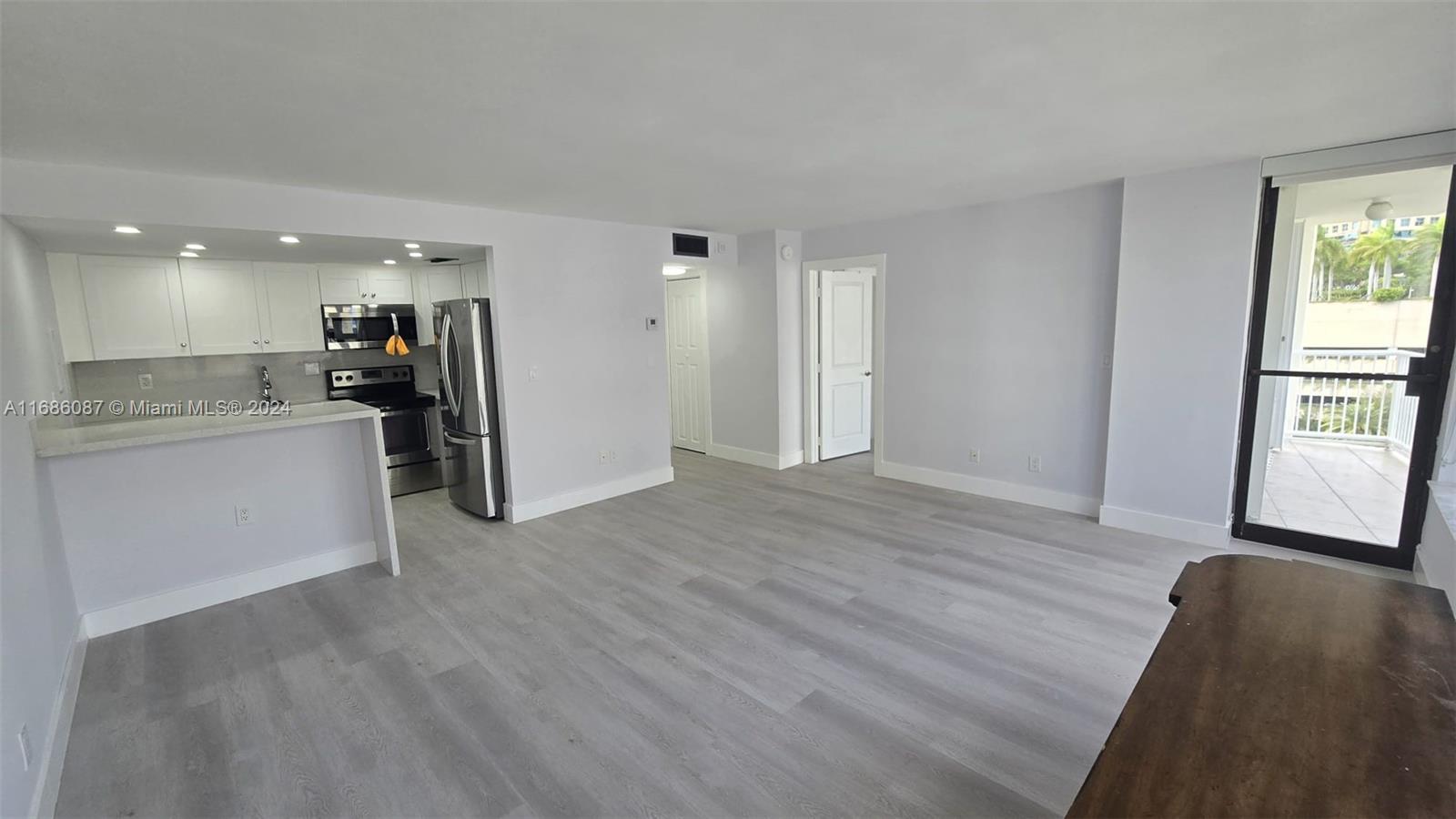 a view of a kitchen cabinets and wooden floor