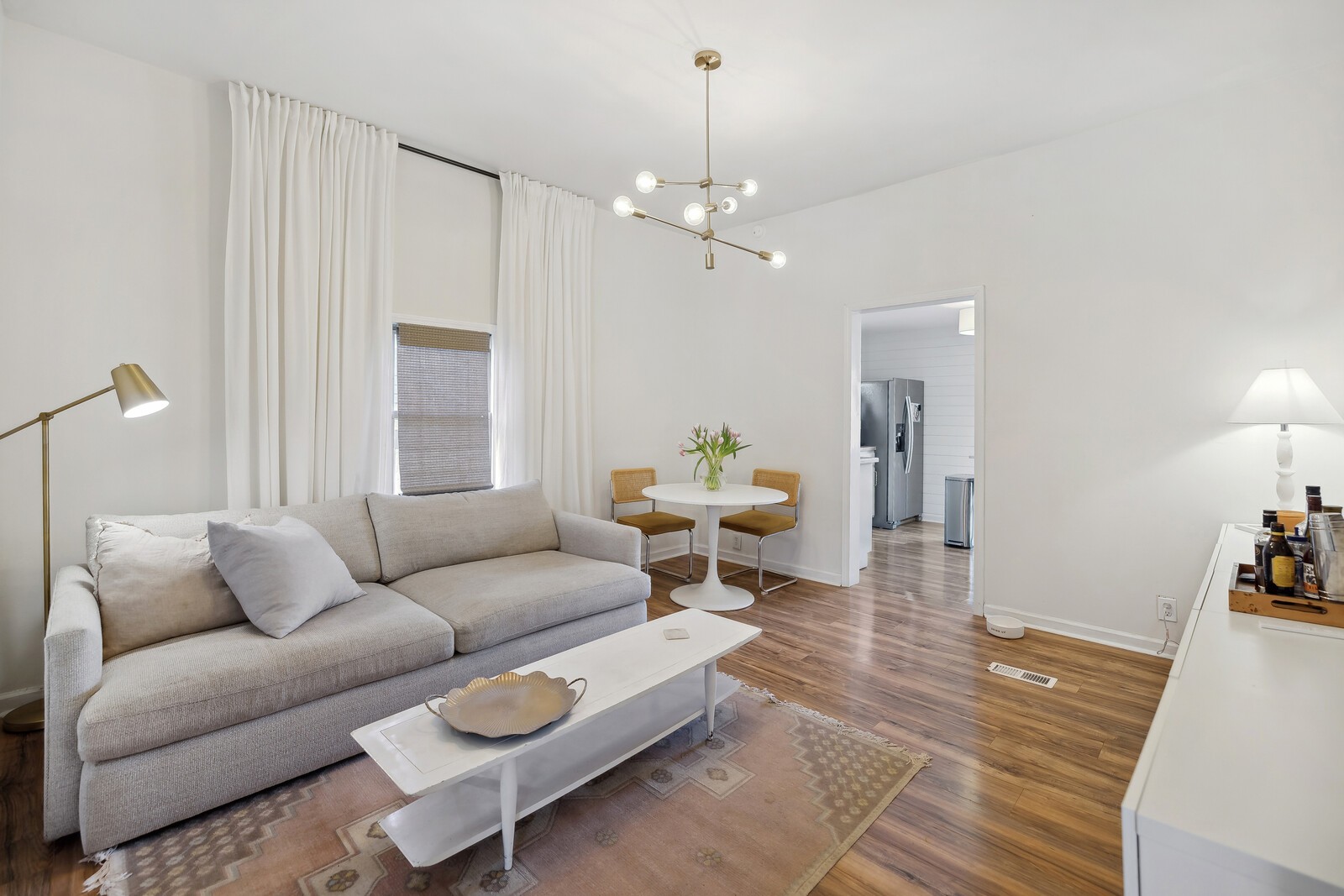 a living room with furniture a couch and a chandelier