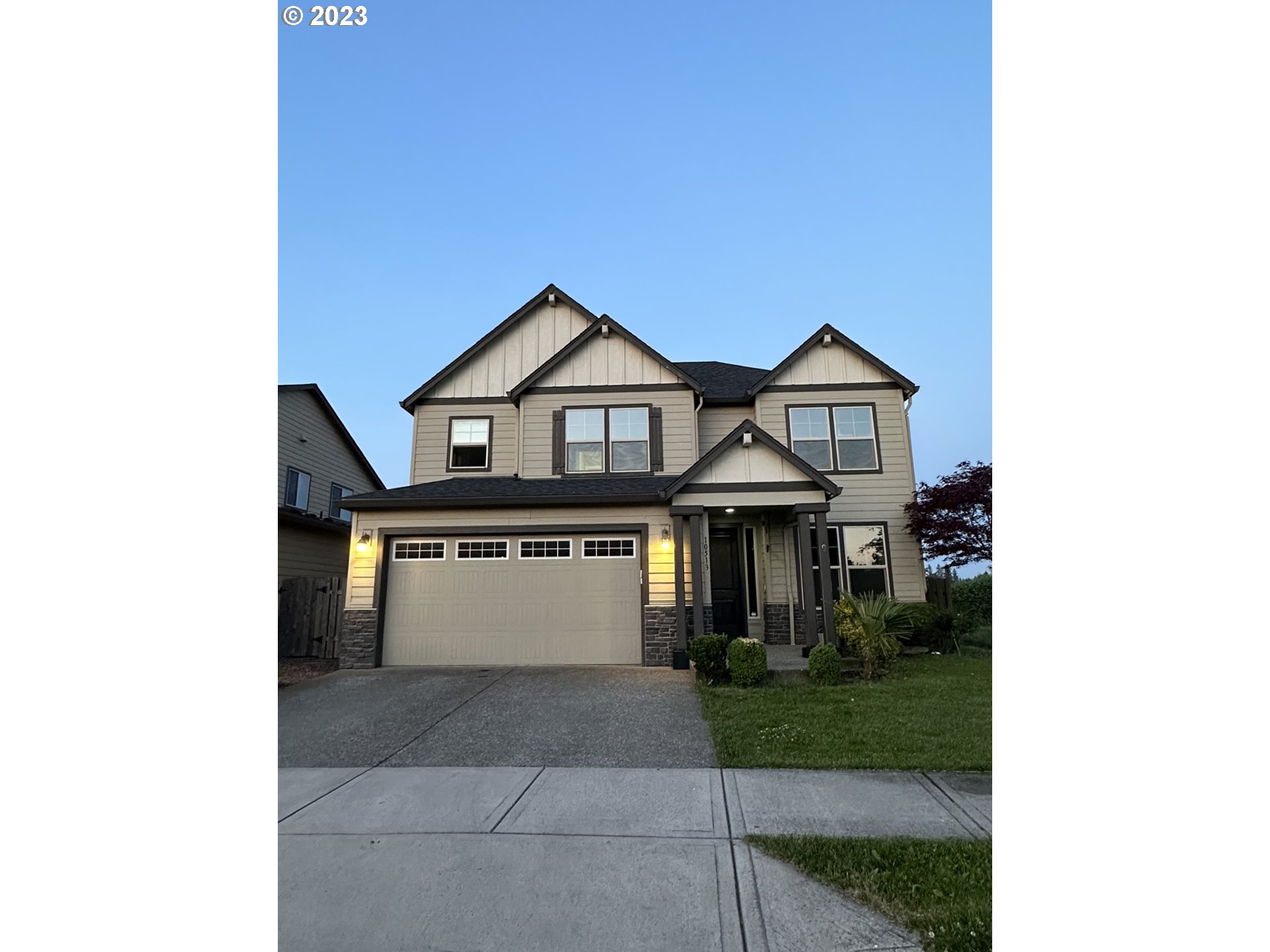 a front view of a house with a yard and garage