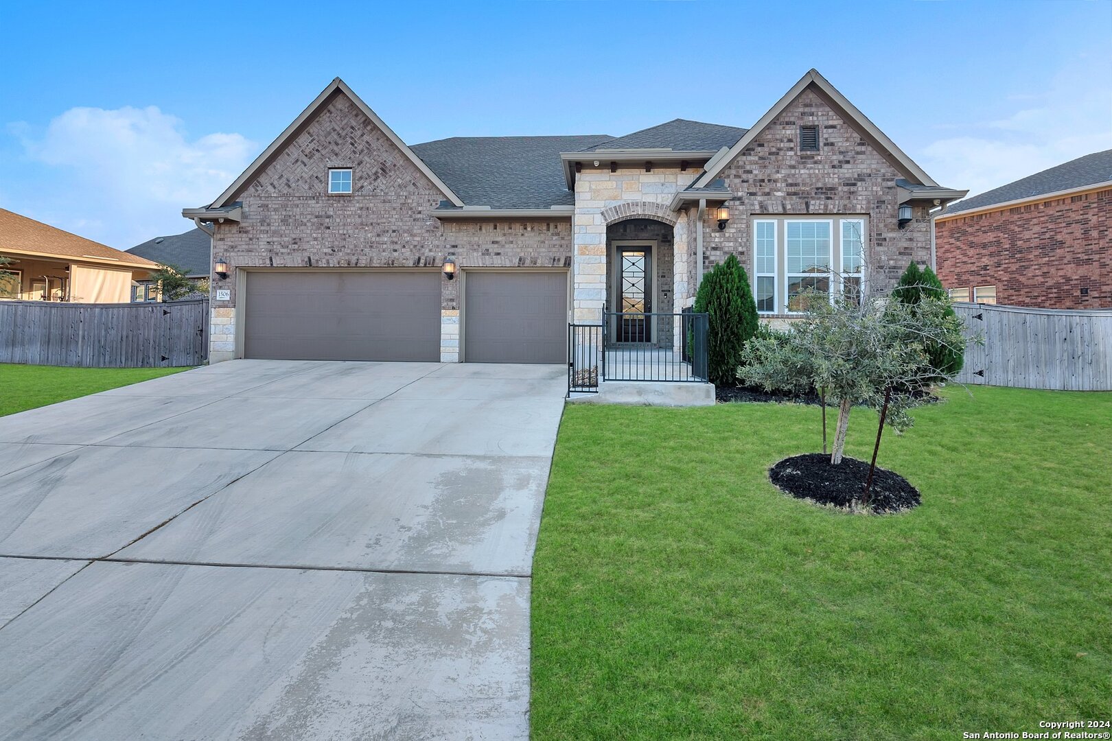 a front view of a house with a garden