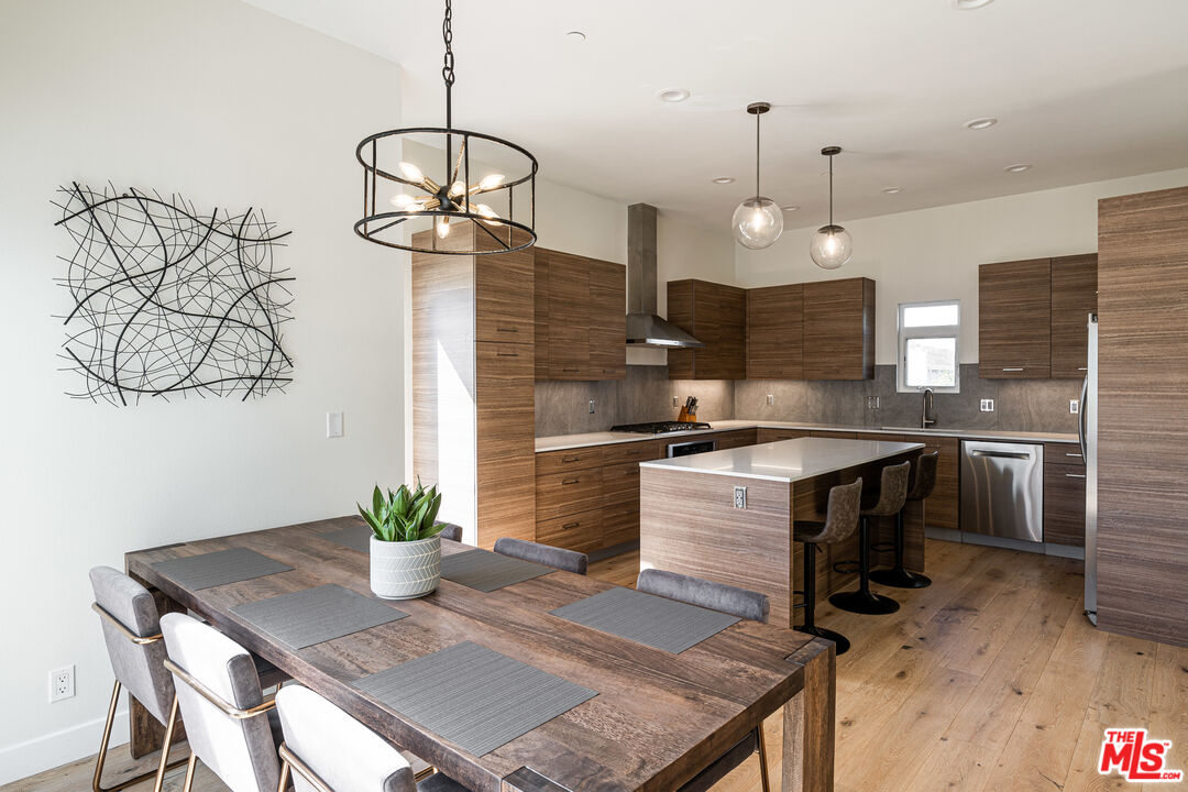 a kitchen with a table and chairs in it