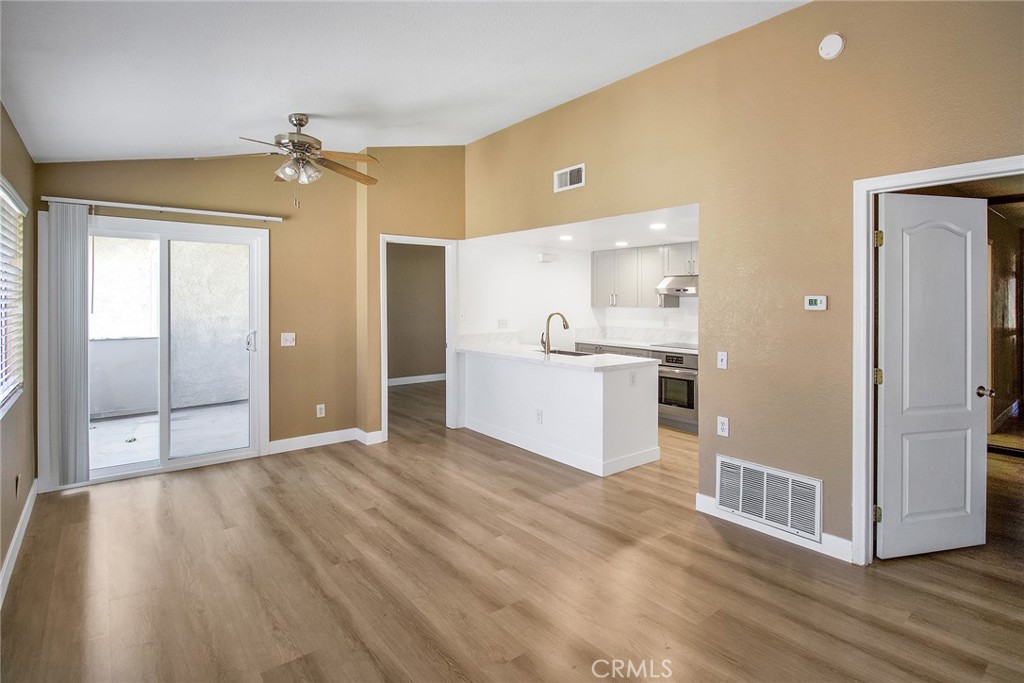 a view of a kitchen with a sink and cabinet with wooden floor