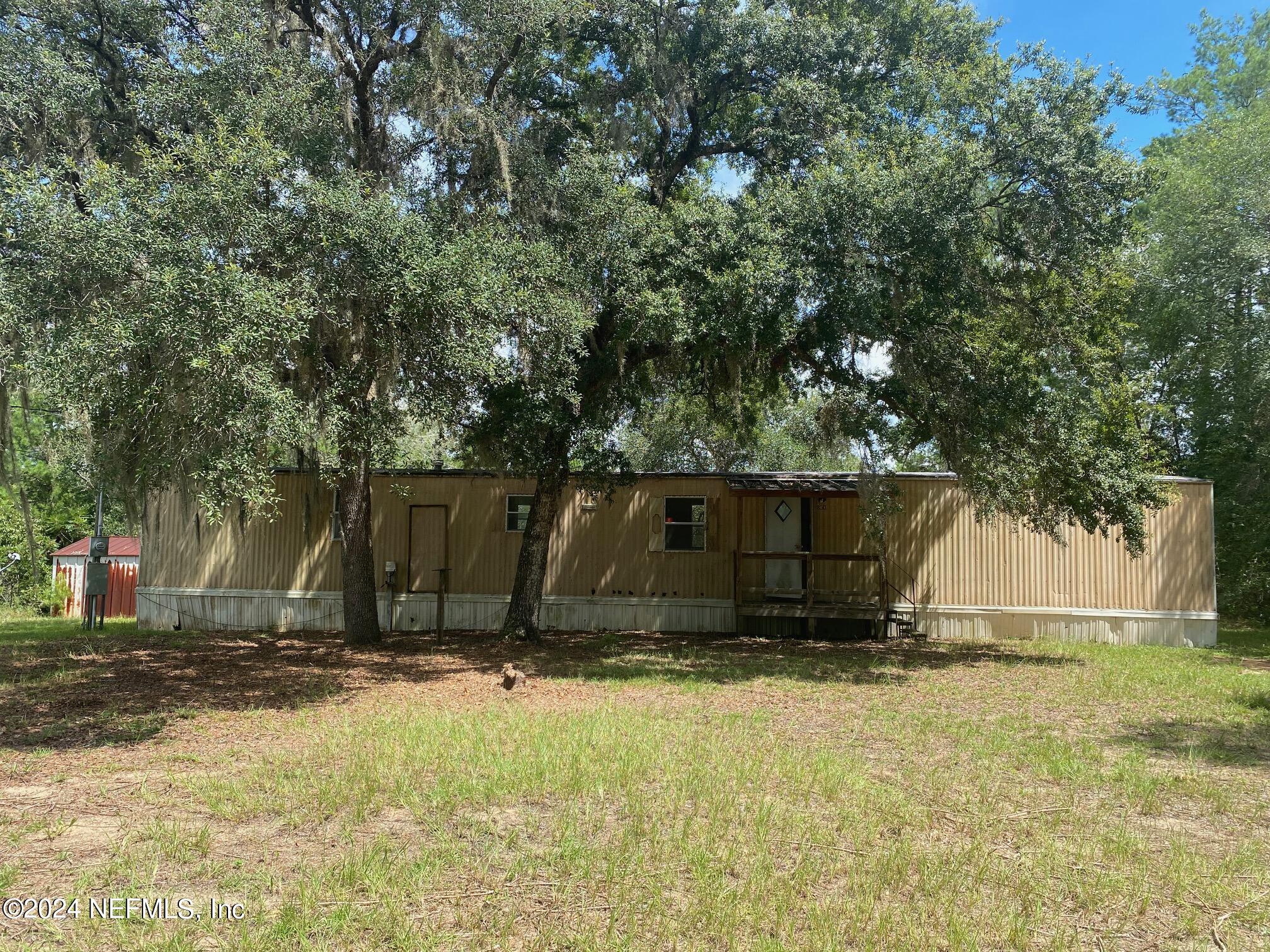 a view of barn with wooden fence