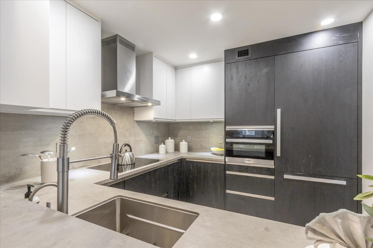 a kitchen with stainless steel appliances granite countertop a sink and cabinets