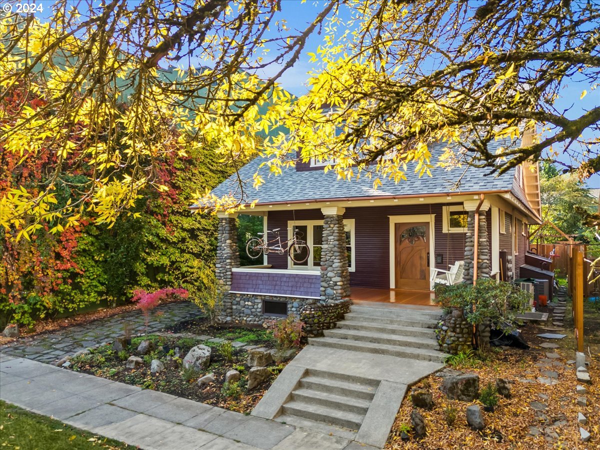 a front view of a house with a garden