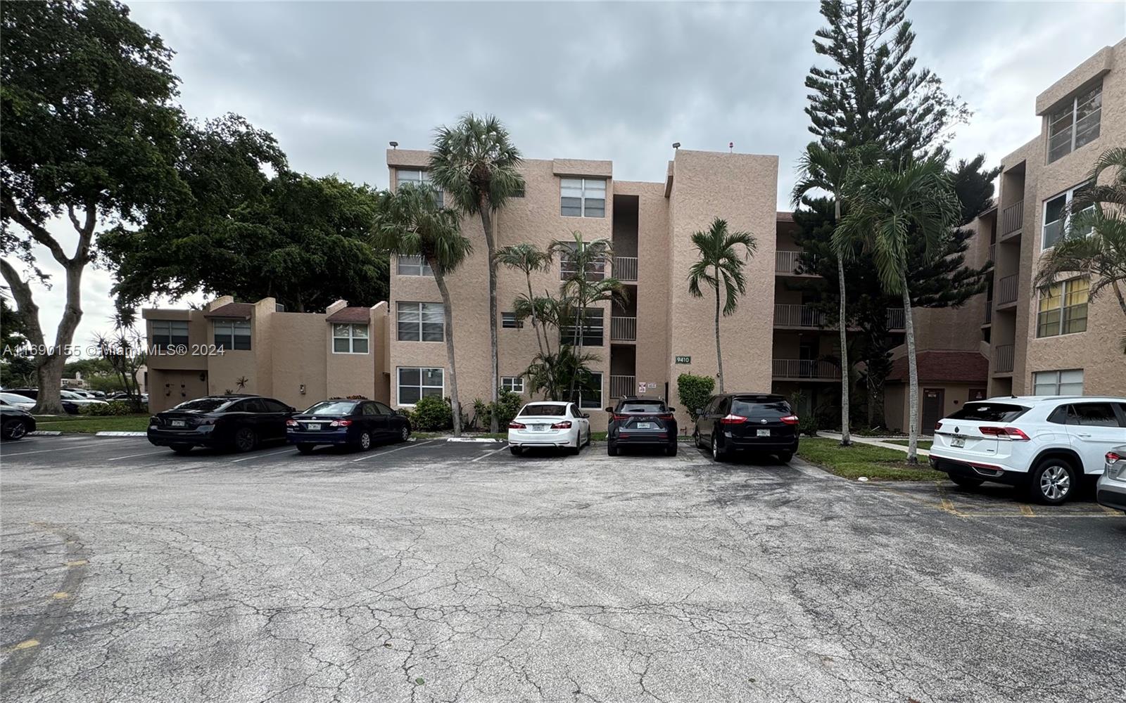 a view of a cars park in front of a building