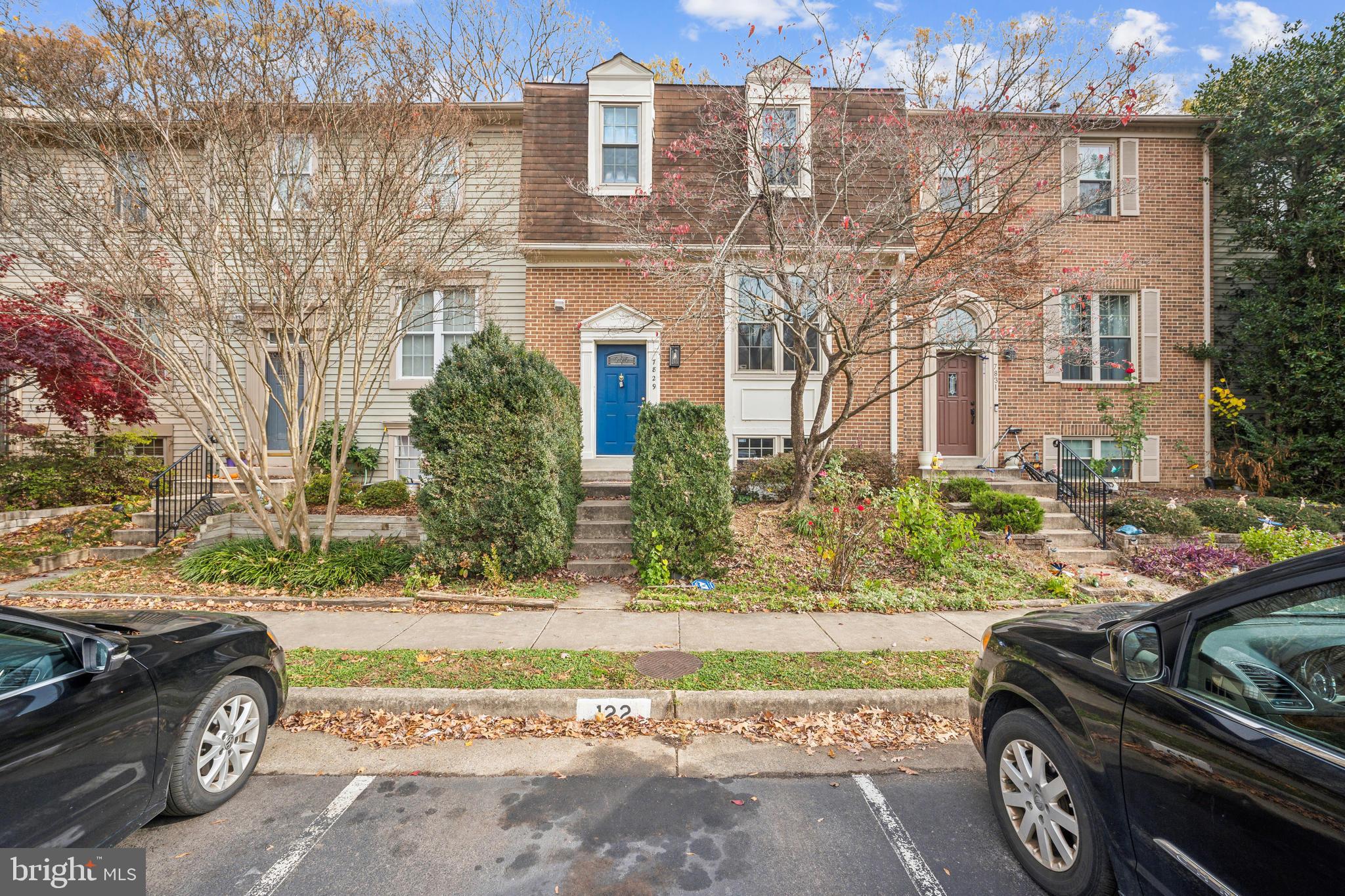 a car parked in front of a brick house