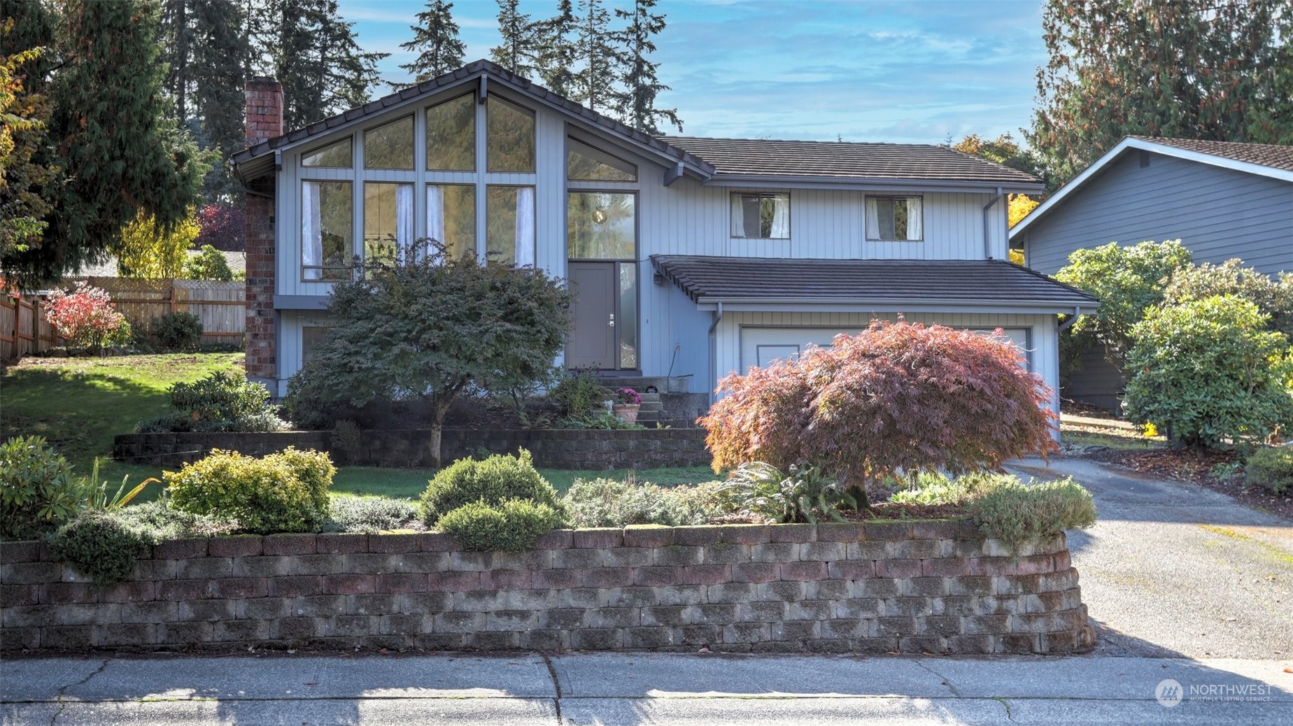 a front view of a house with a yard and outdoor seating