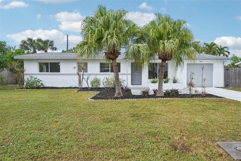 a front view of house with yard and trees