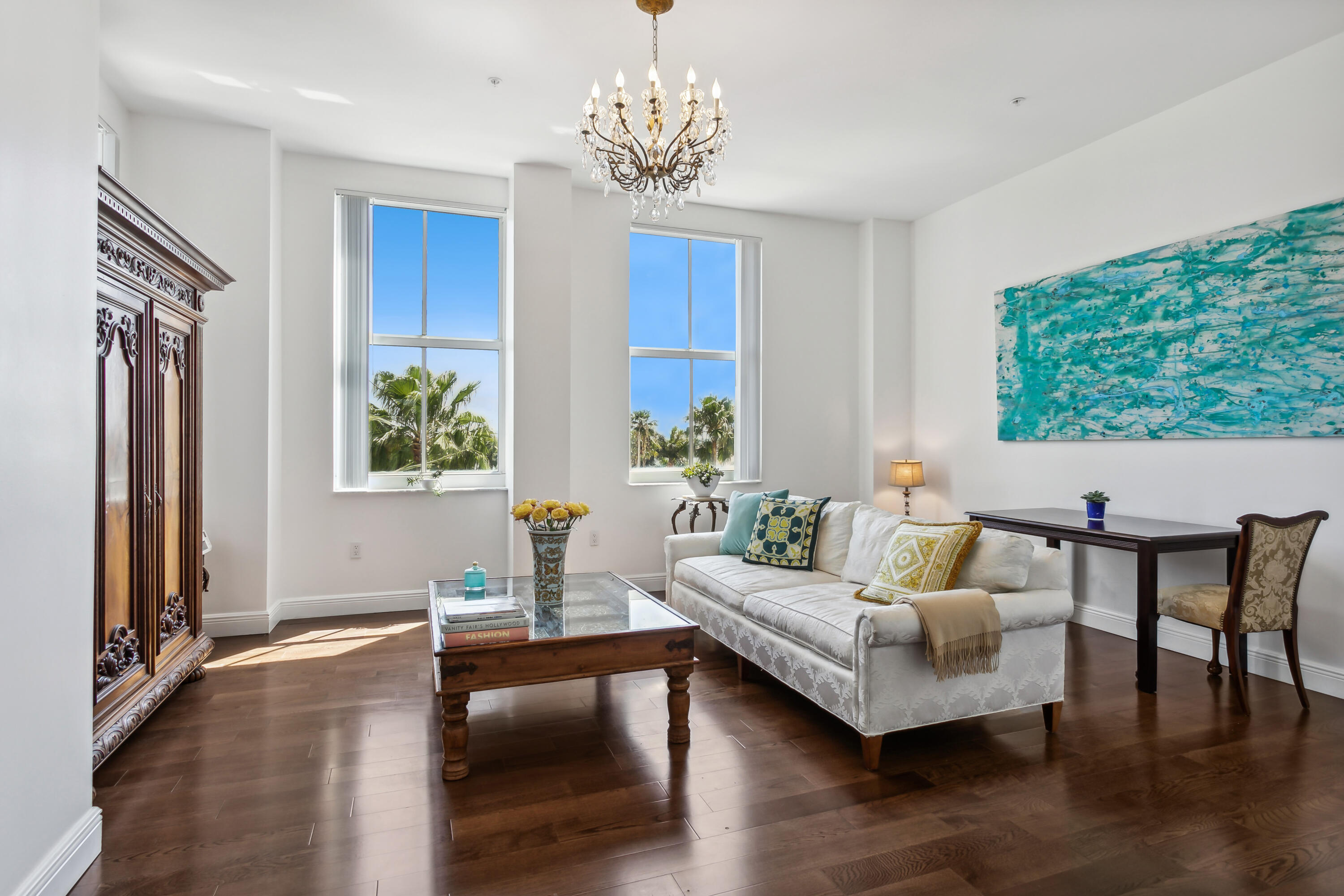 a living room with furniture and a chandelier