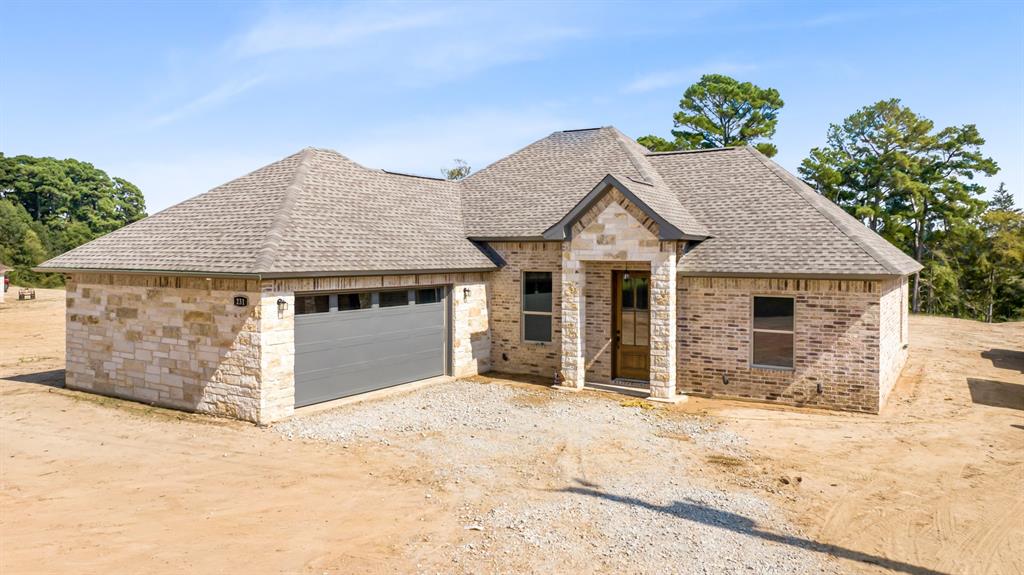 a view of a house with a yard and garage