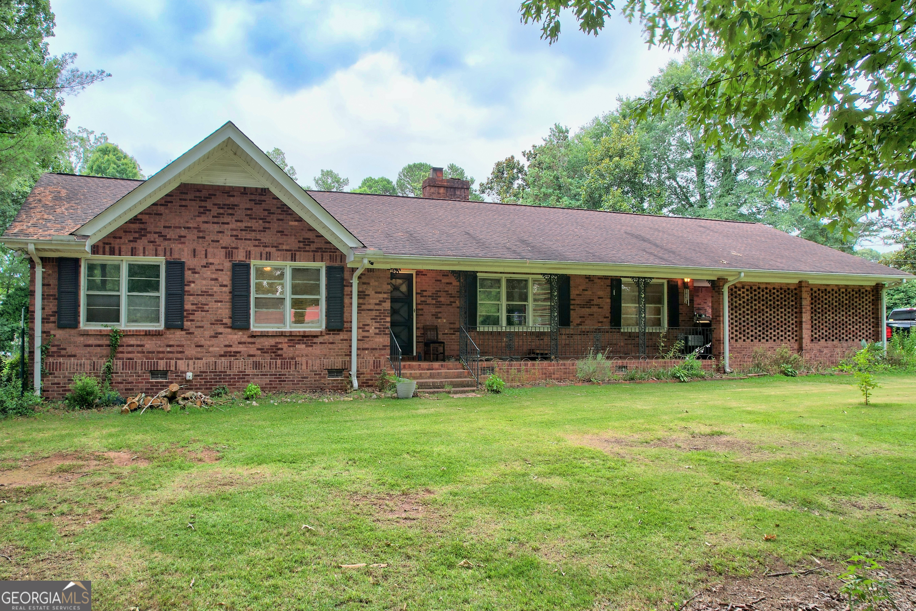 a front view of a house with a garden and porch