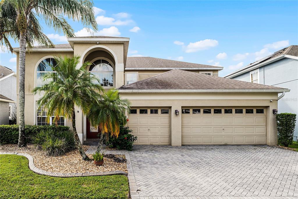 a front view of a house with a yard and garage