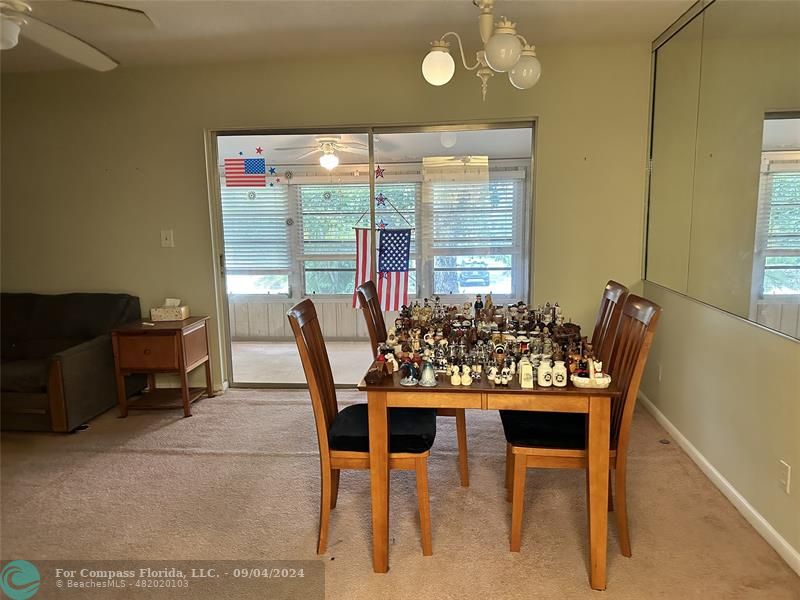 a view of a dining room with furniture and window