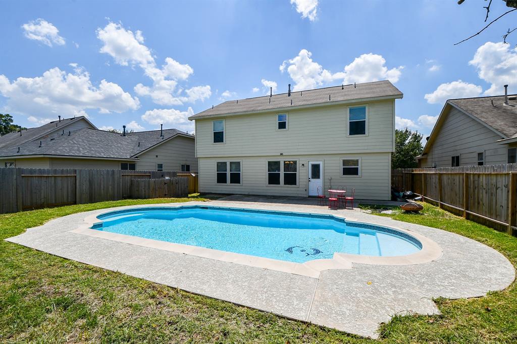 a view of a house with swimming pool and porch