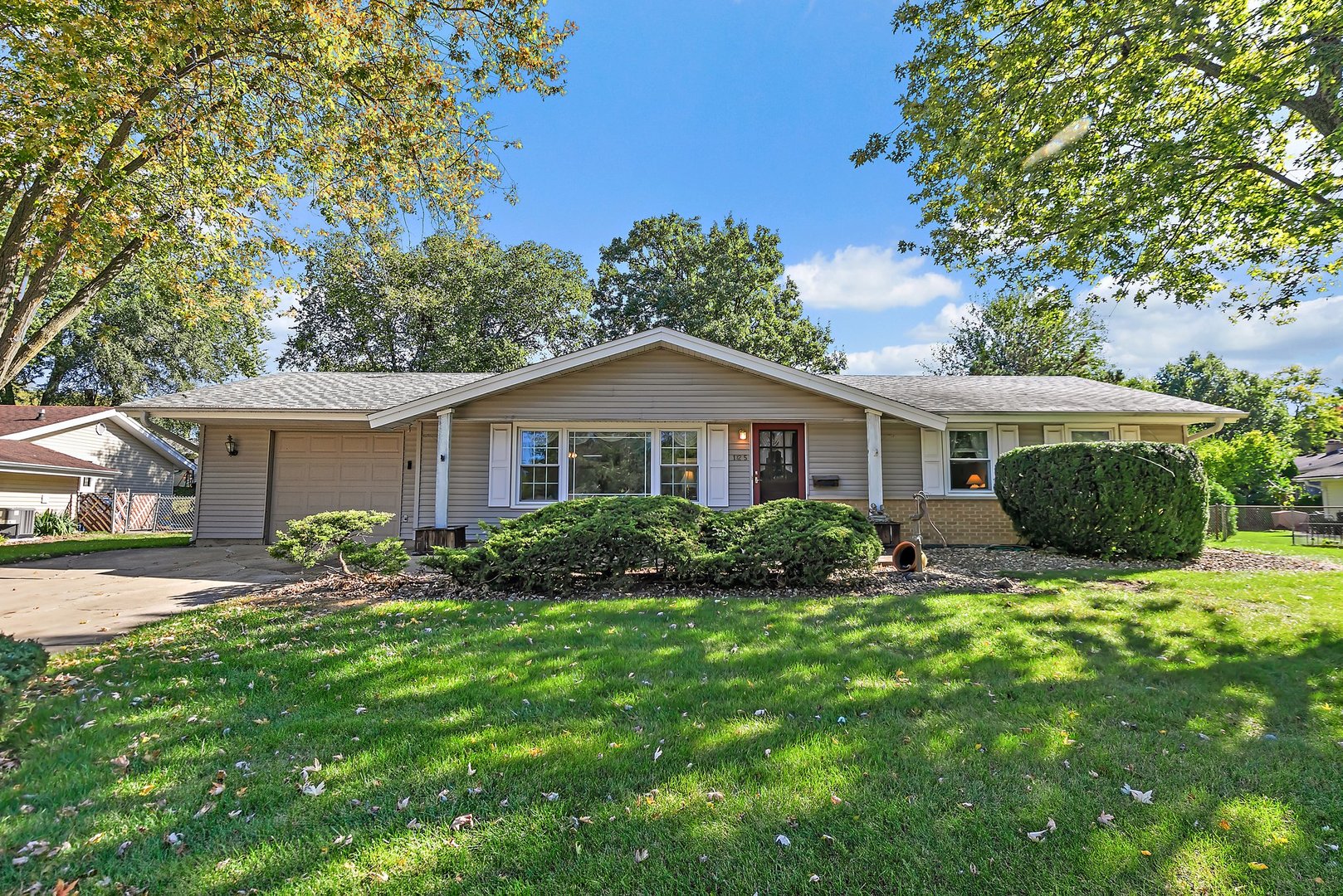 a front view of house with yard and green space