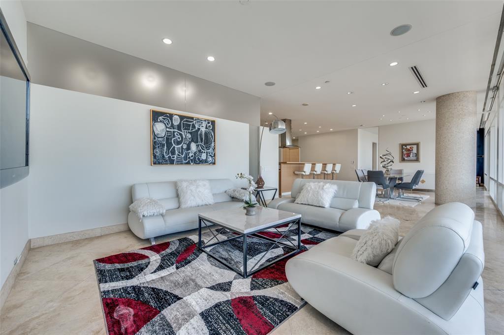 a living room with furniture rug and kitchen view